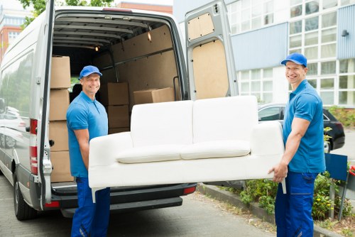 Moving van and packed boxes representing a man with van booking service