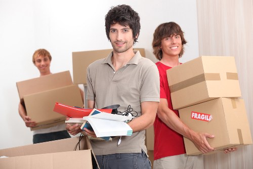 Team members using proper manual handling techniques during a move