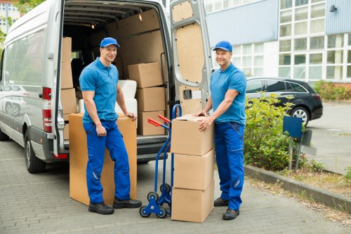 Moving boxes and furniture being loaded for a Holland Park relocation