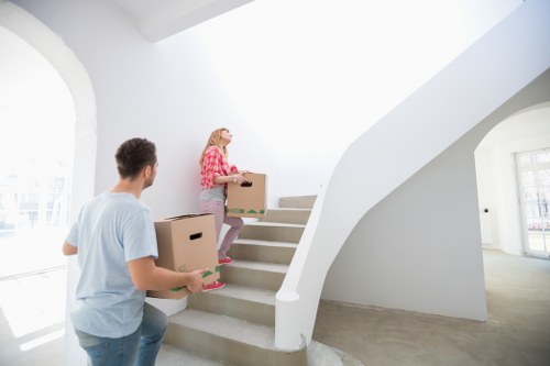 Removal professionals loading furniture for a Holland Park property