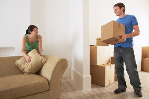 Mover wearing PPE while carrying boxes safely